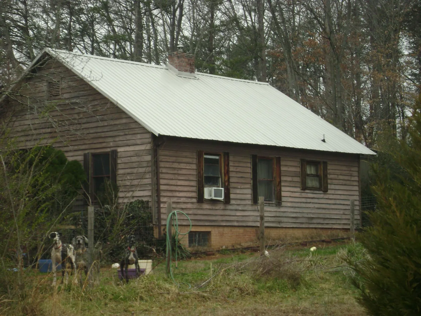 White metal roof on an old wood sided farmhouse, from a Metal Roof Installation job in Whipple